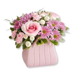 Pink and white flower arrangement in a pink vase