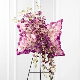 Pink and purple floral standing spray on an easel