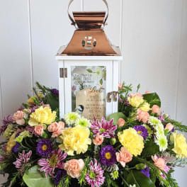 Sympathy lantern surrounded by pastel flowers