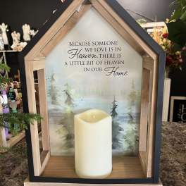 House-shaped memorial sign with a candle and sympathy message