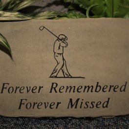 Memorial stone with a golfer illustration and the words Forever Remembered Forever Missed