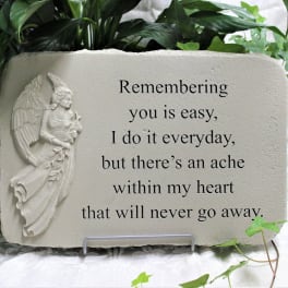 Memorial stone plaque with an angel relief and engraved text