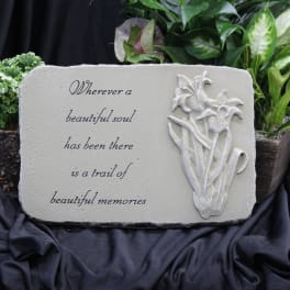 Memorial plaque with a floral relief and sympathy quote