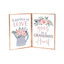 Two floral-themed printed signs with a watering can and "Grandma's Heart" text