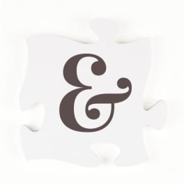 White puzzle piece with a dark ampersand symbol