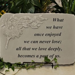 Decorative memorial plaque with a leaf relief and quote