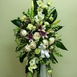 Tall white and purple floral standing spray with ribbon
