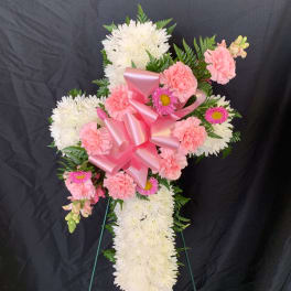 Pink and white floral standing spray with a large pink ribbon