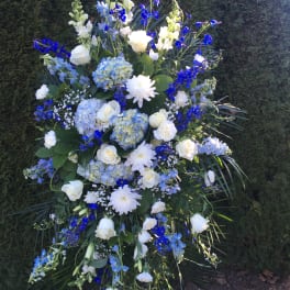 Tall blue and white floral standing spray with roses and hydrangeas