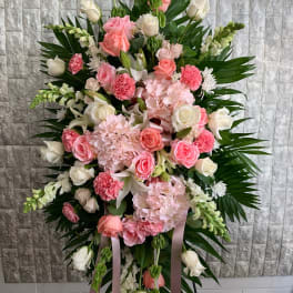 Standing floral spray with pink and white roses and carnations