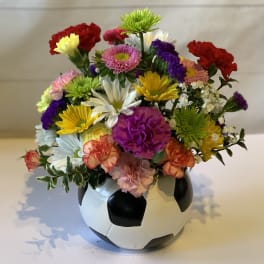 Mixed flowers arranged in a soccer ball vase