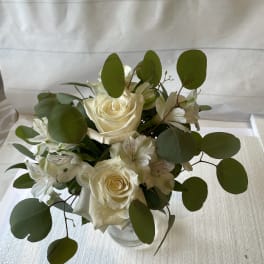 White rose bouquet with white alstroemeria in a clear vase