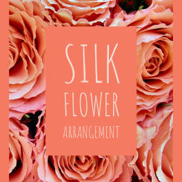 Silk flower arrangement with peach roses and a coral label
