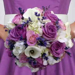 Purple and white bridal bouquet with roses and calla lilies