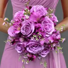 Bridal bouquet of purple roses and small accent flowers