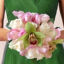 Bridal bouquet of pink and white roses with green orchids