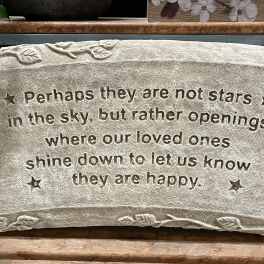 Rectangular stone memorial plaque with engraved sympathy quote and small star accents.