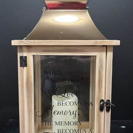 Wooden memorial lantern with a candle and sympathy quote