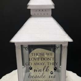 White memorial lantern with a sympathy quote and paw prints