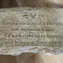 Stone memorial bench with engraved sympathy verse and heart detail