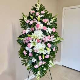 Standing floral spray with pink and white flowers on an easel