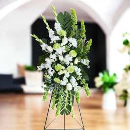 Tall white and green floral standing spray on an easel