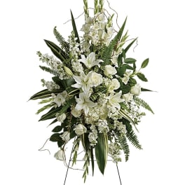 White floral standing spray on a black easel