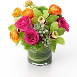 Pink and orange flowers arranged in a glass vase