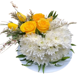 Low arrangement of yellow roses and tulips with white mums on a white plate
