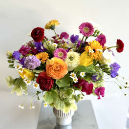 Colorful mixed bouquet in a white vase