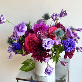 Bouquet of purple and pink flowers in a white vase