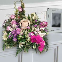 Pink and white floral arrangement with a small basket centerpiece