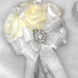 White rose bouquet with a large silver ribbon and jeweled center