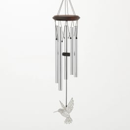 Silver wind chime with a hummingbird ornament hanging from a dark top frame