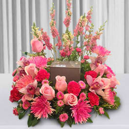 Pink floral arrangement surrounding a brown box centerpiece