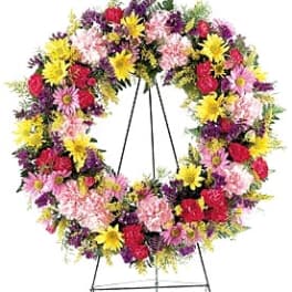 Colorful floral wreath on a metal stand