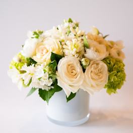 Cream and white flower arrangement in a white vase