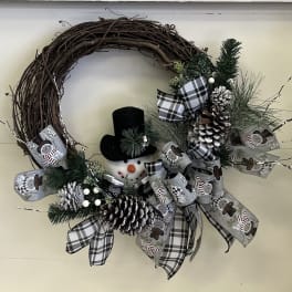 Christmas wreath with a snowman, pinecones, and plaid ribbon