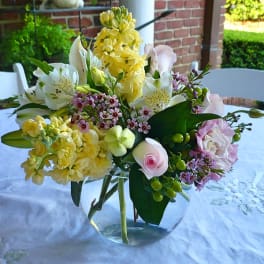 Mixed pastel bouquet in a clear glass vase on a table