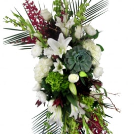 Tall floral spray with white lilies, roses, and green accents