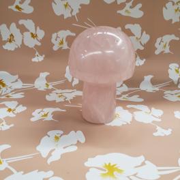 Pink mushroom-shaped decorative object on a floral patterned background