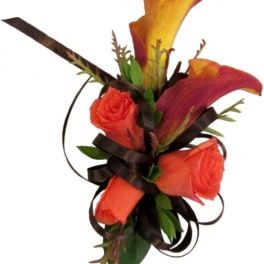 Orange roses and calla lilies with dark ribbon accents