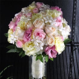 Pink and cream rose bouquet in a clear vase