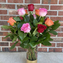 Bouquet of multicolored roses in a clear glass vase