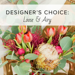 Loose bouquet with pink tulips, a protea, and eucalyptus.