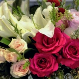 Bouquet of pink roses and white calla lilies with small accent flowers