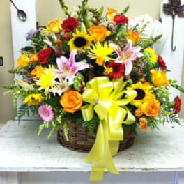 Mixed flower basket with a yellow ribbon bow