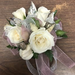 Small bouquet of white roses with pink ribbon and silver accents