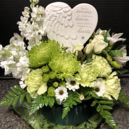 White and green sympathy arrangement with a heart memorial plaque