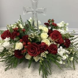 Red and white rose arrangement with a clear glass cross